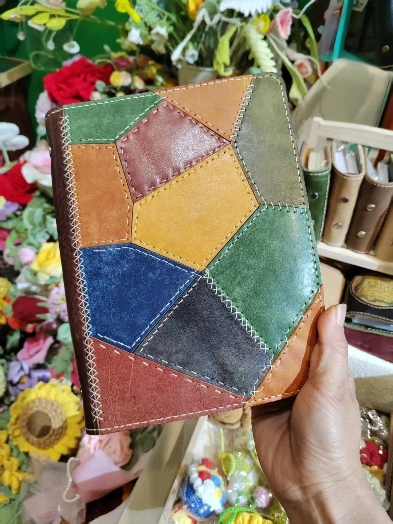 A colourful patchwork leather notebook from the LazyingArt shop